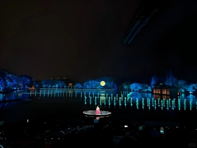 Night scene of Impression West Lake live show, water stage with performer