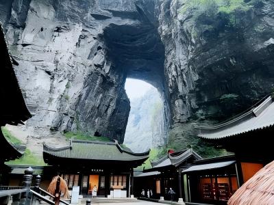 Wulong Three Natural Bridges in Chongqing with giant stone arches, cliffs, ancient buildings, and karst scenery