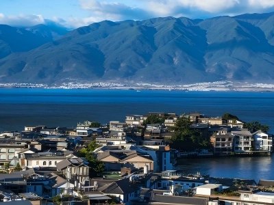 Overlooking lakeside residences by Erhai Lake, Dali, distant rolling Cangshan mountains