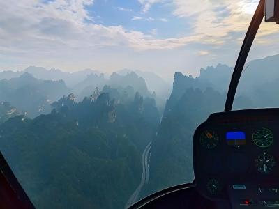 Aerial view of Zhangjiajie National Forest Park's towering sandstone peaks seen from a helicopter flight
