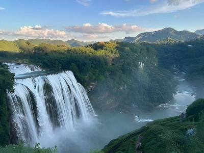 Huangguoshu grand waterfall surrounded by green mountain valley Guizhou China