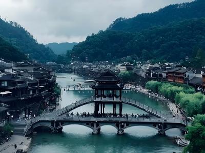 Scenery of ancient covered arch bridge on Tuojiang River, historic Fenghuang Ancient Town surrounded by green mountain ranges