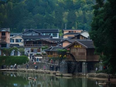 Yunshuiyao Ancient Town in Fujian featuring a wooden waterwheel, village houses, and green mountains