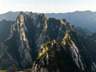 Dramatic mountain peaks and rugged cliffs of Mount Hua in China under a clear sky