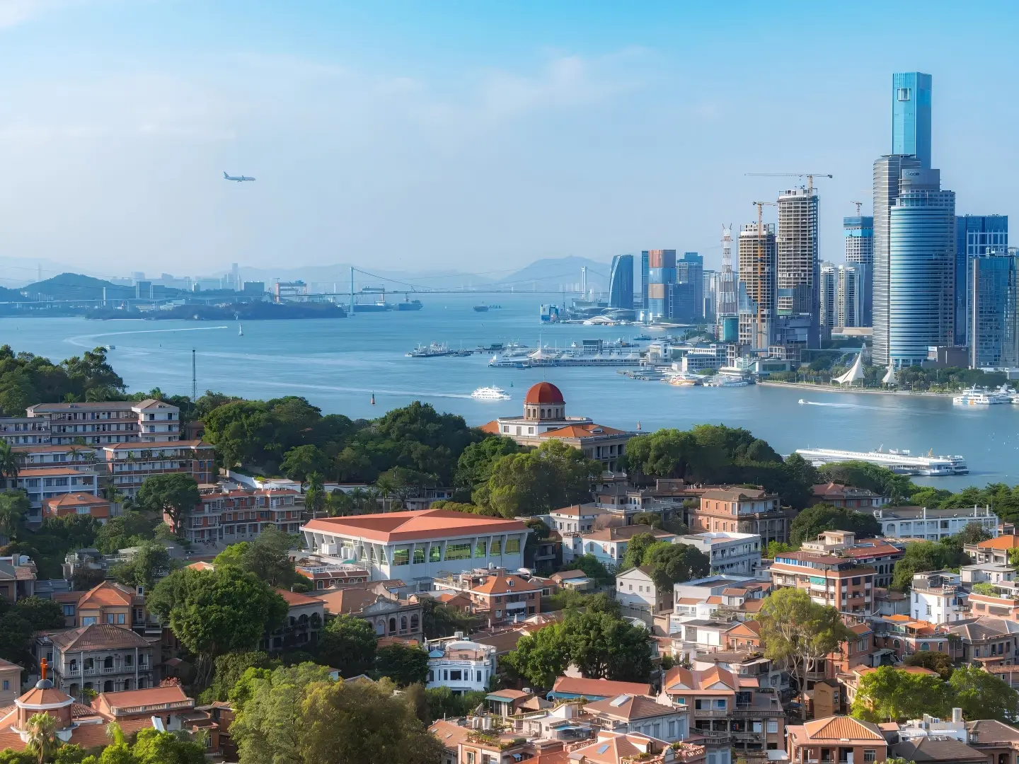 Panoramic view of Gulangyu Island with old villas and Xiamen skyline across the sea