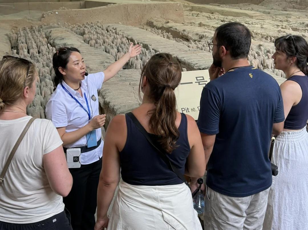 Tour guide introducing Terracotta Army to foreign tourists Xi'an