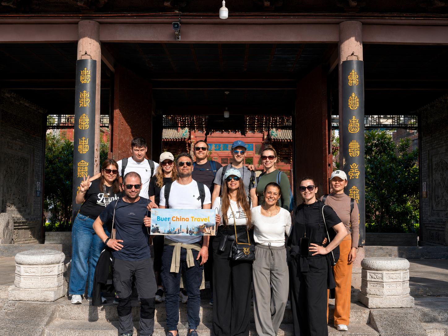 Tour group posing at ancient building entrance