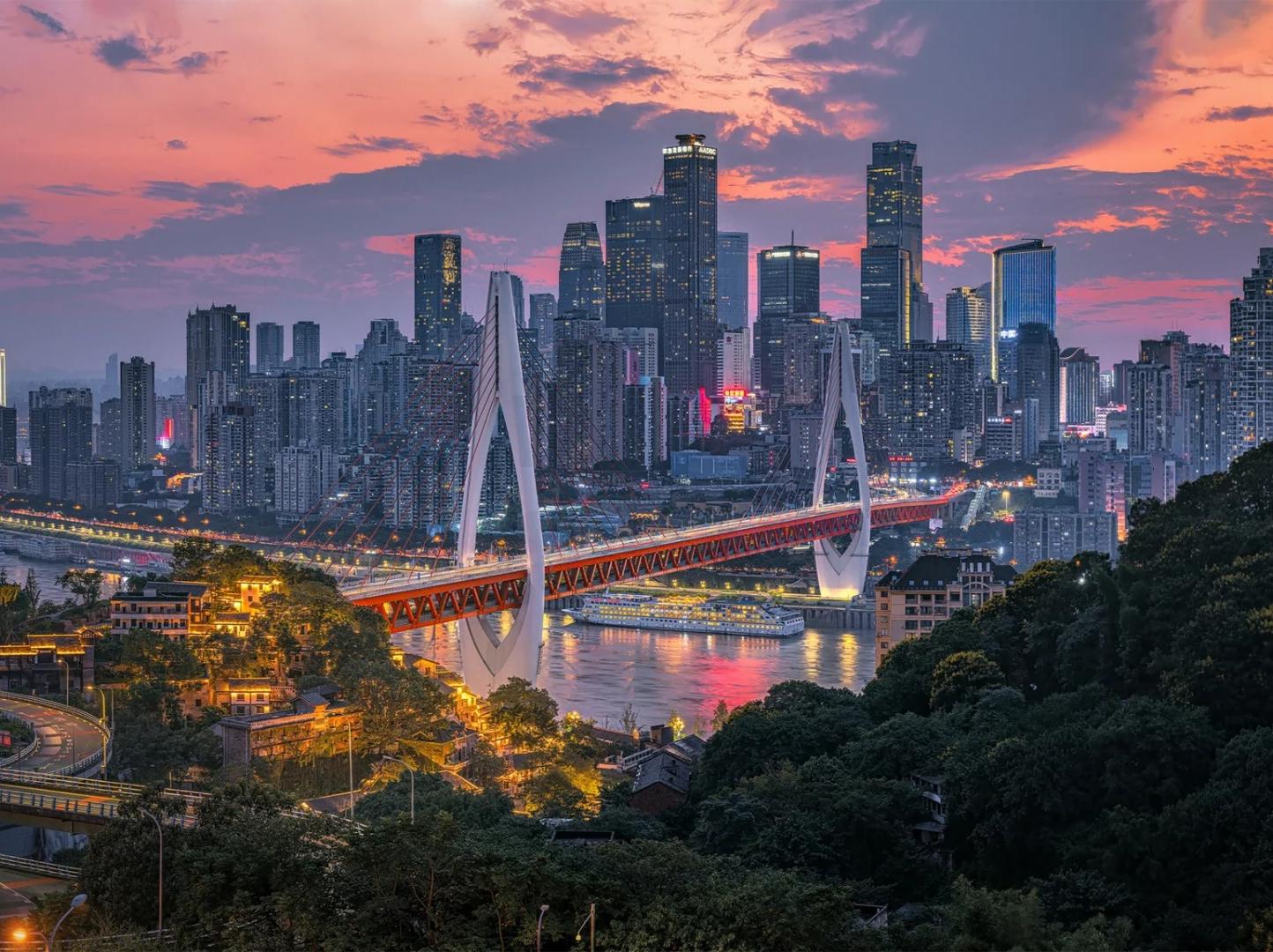 Stilt house complex lit up at night, traditional cliffside architecture, spectacular city nightscape in Chongqing China
