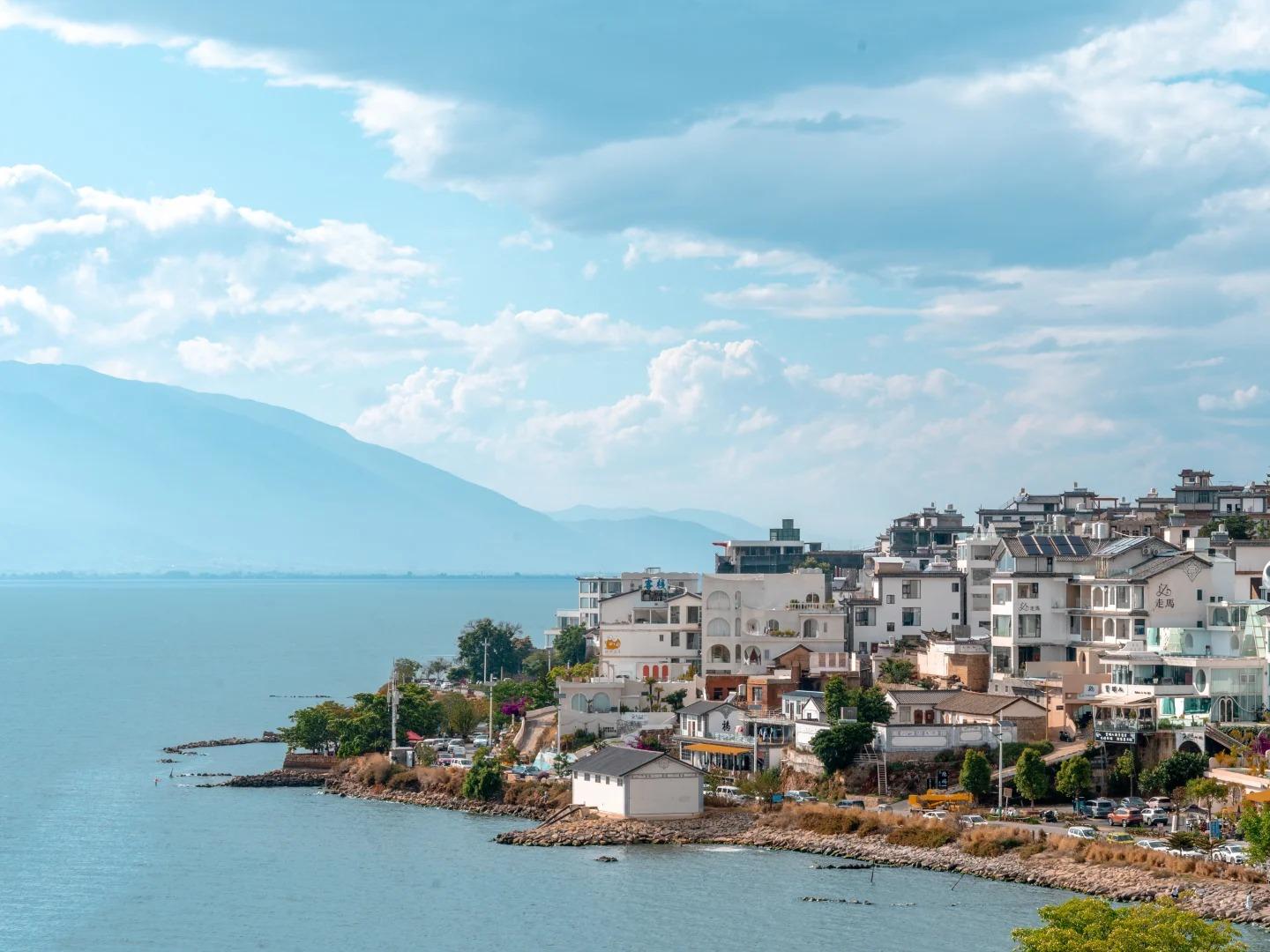 Overlooking lakeside residences by Erhai Lake, Dali, distant rolling Cangshan mountains