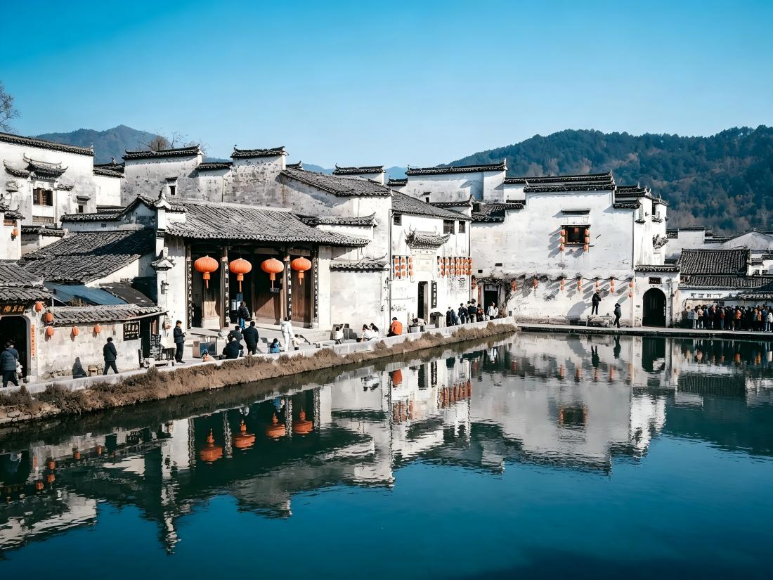 Hongcun waterfront, Huizhou-style houses, black tiled roofs, red lanterns, blue pond, reflections and green hills