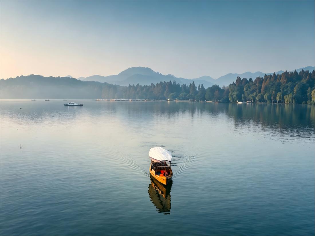 Hangzhou West Lake, tourist boat, calm lake and soft morning light