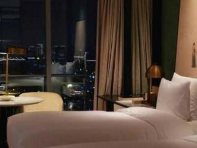 Guest room at Hangzhou Grand Canal hotel, big window with sparkling downtown night skyline