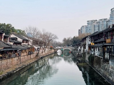 Calm canal waterway of Xiaohe Straight Street, old dwellings and stone arch bridge on Hangzhou Grand Canal
