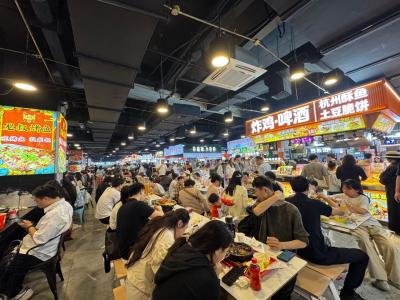 Indoor street stalls in Wulin Night Market are crowded with people