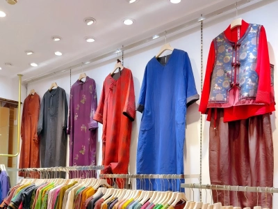 Colorful Chinese-style dresses and clothing hanging in a silk boutique Colorful Chinese-style dresses and clothing hanging in a silk boutique