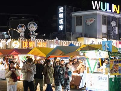 Wulin Night Market Hangzhou with illuminated stalls and visitors at night Wulin Night Market Hangzhou with illuminated stalls and visitors at night