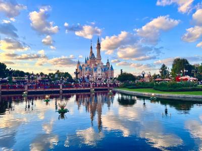 Shanghai Disneyland castle with lake reflection and fairytale landscape