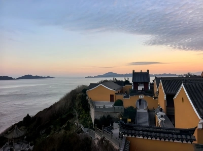 Putuo Mountain temple buildings overlooking the sea at sunset