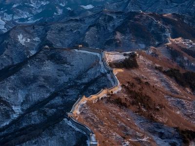 Snow-covered Mutianyu Great Wall winding through mountain ridges