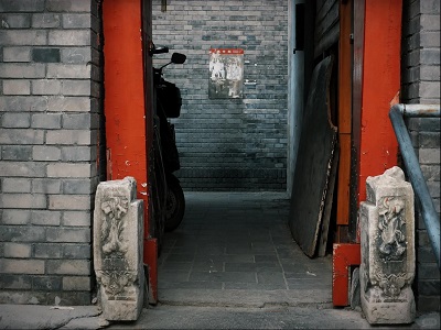 Traditional Beijing courtyard entrance with red gate