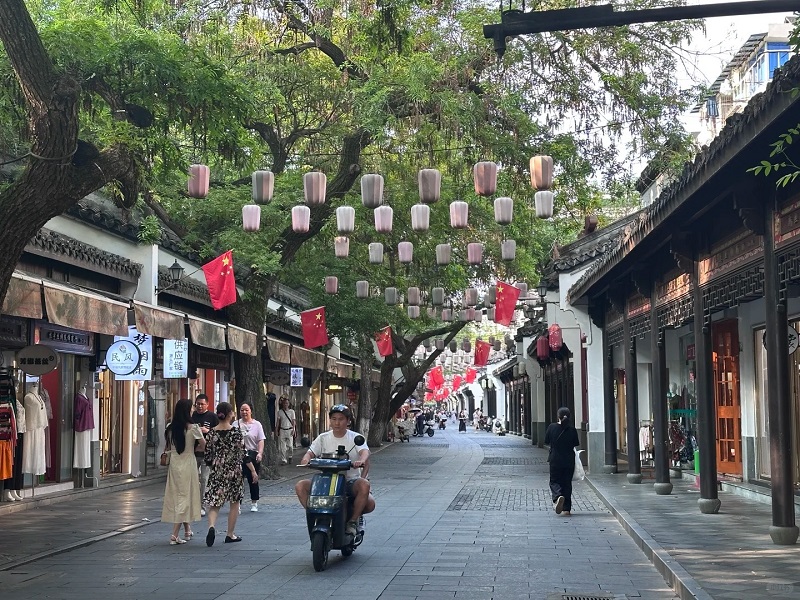 Bustling pedestrian street of Hangzhou Silk Market with traditional shops and lanterns Bustling pedestrian street of Hangzhou Silk Market with traditional shops and lanterns