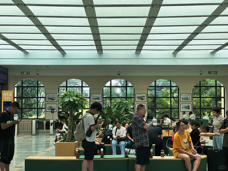 Travelers inside Beijingxi Railway Station waiting hall