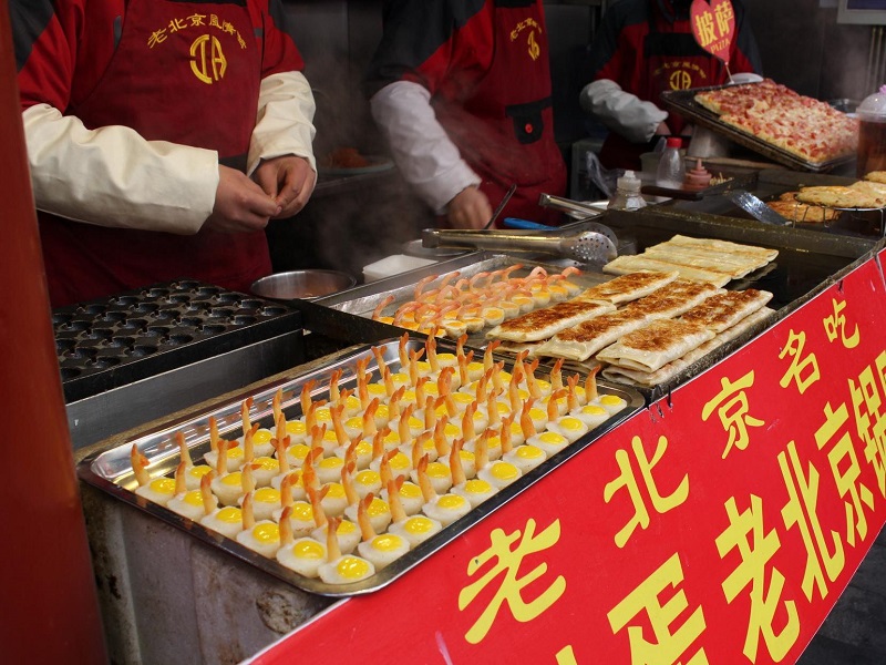 Street food vendor cooking classic Beijing local delicacies