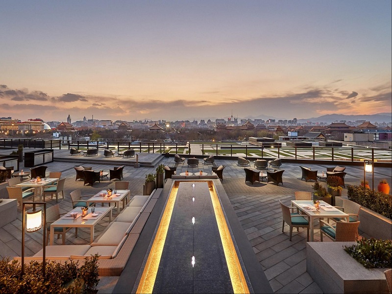 Rooftop restaurant terrace with Beijing old city sunset view