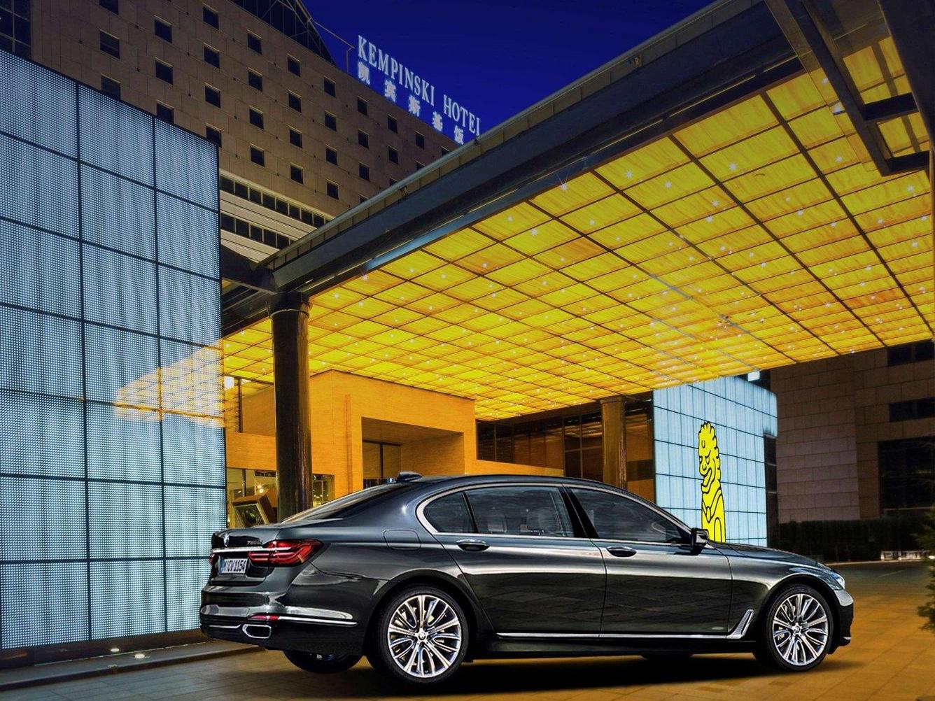 Night exterior of Kempinski Beijing hotel with luxury car